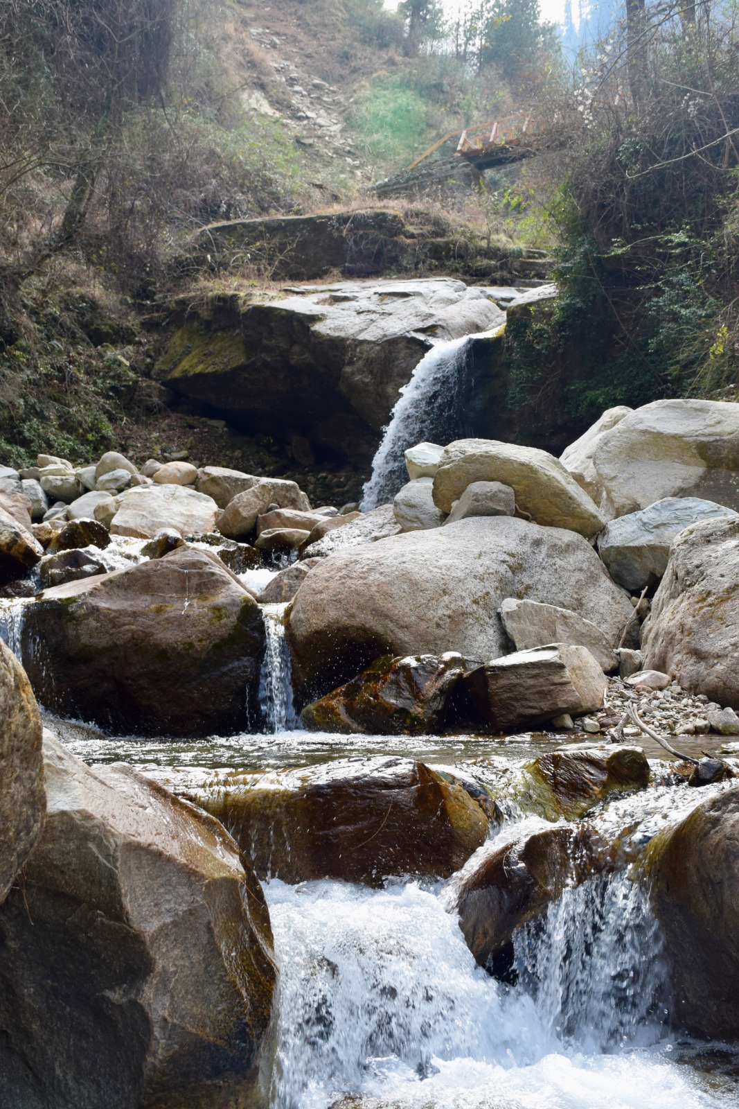 Choii Waterfall cascading over moss-covered rocks in Tirthan Valley